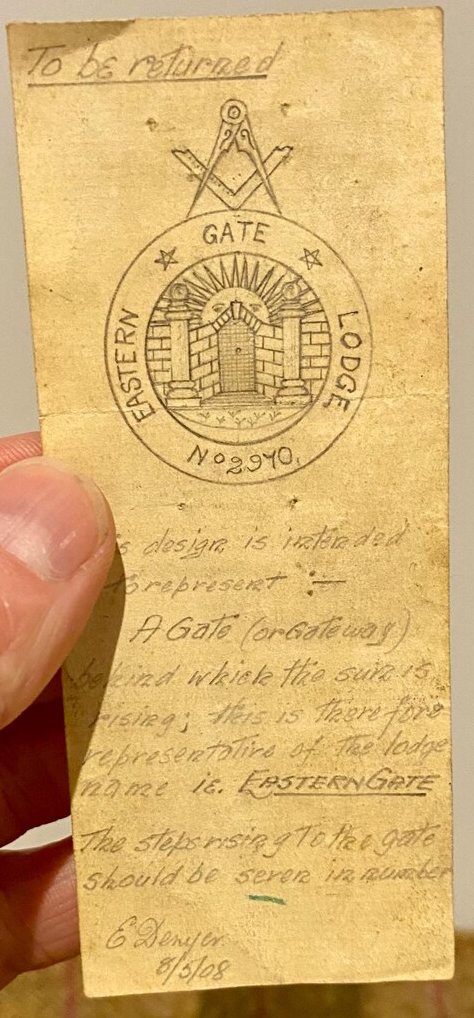 A small, worn card headed “To be returned”, bearing a pencil drawing of the lodge’s device — a gate between two pillars with the sun rising behind it, lettered EASTERN GATE LODGE No. 2970 — and several lines of handwritten explanation below it, signed and dated.
